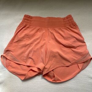 Lululemon sunny coral 4” high rise lined shorts.